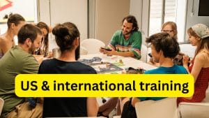 Photo of people at a Stay Grounded conference sitting around a table chatting and laughing.